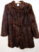 A vintage fur coat with fur buttons and
