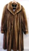 A full length mink coat with cuffed slee