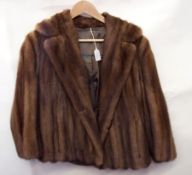 A mink jacket with full collar and brace