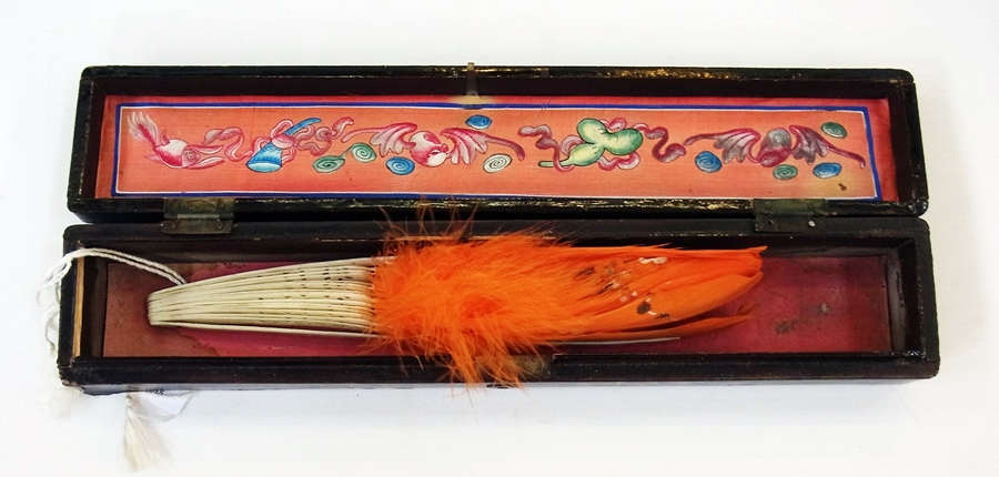 Oriental fan with orange feathers, handp