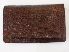 Alligator skin clutch bag fitted with ma