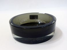 A grey glass ashtray