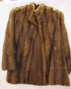 A vintage fur coat, collarless