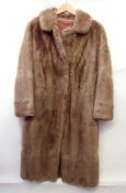 A light brown full length vintage fur co