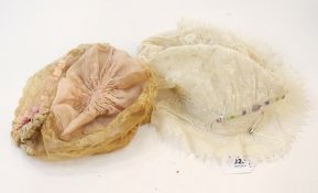A lace bonnet with small coloured embroi