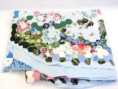 A modern patchwork quilt backed in pale