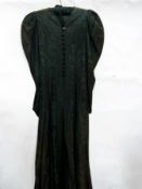 An Edwardian black watered silk coat, le