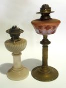 Four oil lamps, two with glass bases and