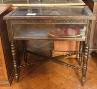 A carved stained oak display table, with