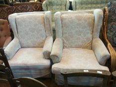 Two wing armchairs upholstered in cream