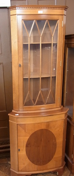 A reproduction bow-front mahogany corner
