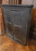 An old stained oak corner cupboard, the