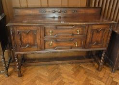 A reproduction oak dresser, with two cen