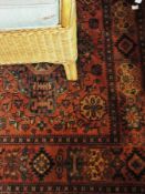 A Baluchi pattern wool rug with overall