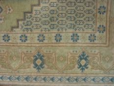 Eastern design wool rug, pale green fiel
