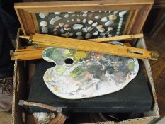 Framed picture of shells, artist's equip