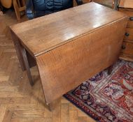 A 19th century oak drop-leaf dining tabl