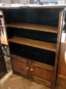 An old oak open bookcase with a pair of