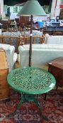 A circular topped cast metal garden tabl