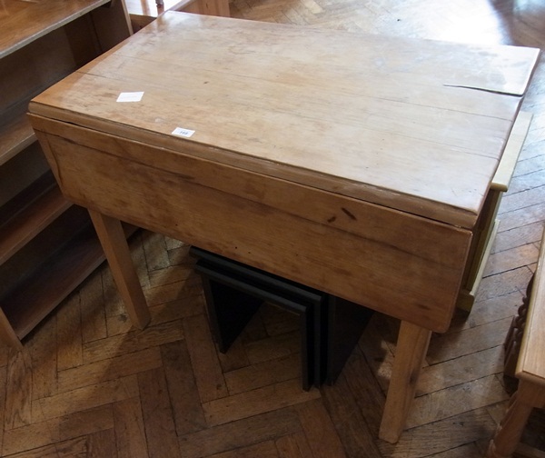 An old pine drop leaf table with frieze