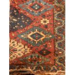 Antique Eastern wool rug having central