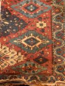 Antique Eastern wool rug having central