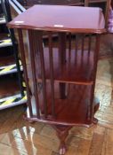 Reproduction mahogany revolving bookcase with slatted sides and two shelves on cabriole legs to