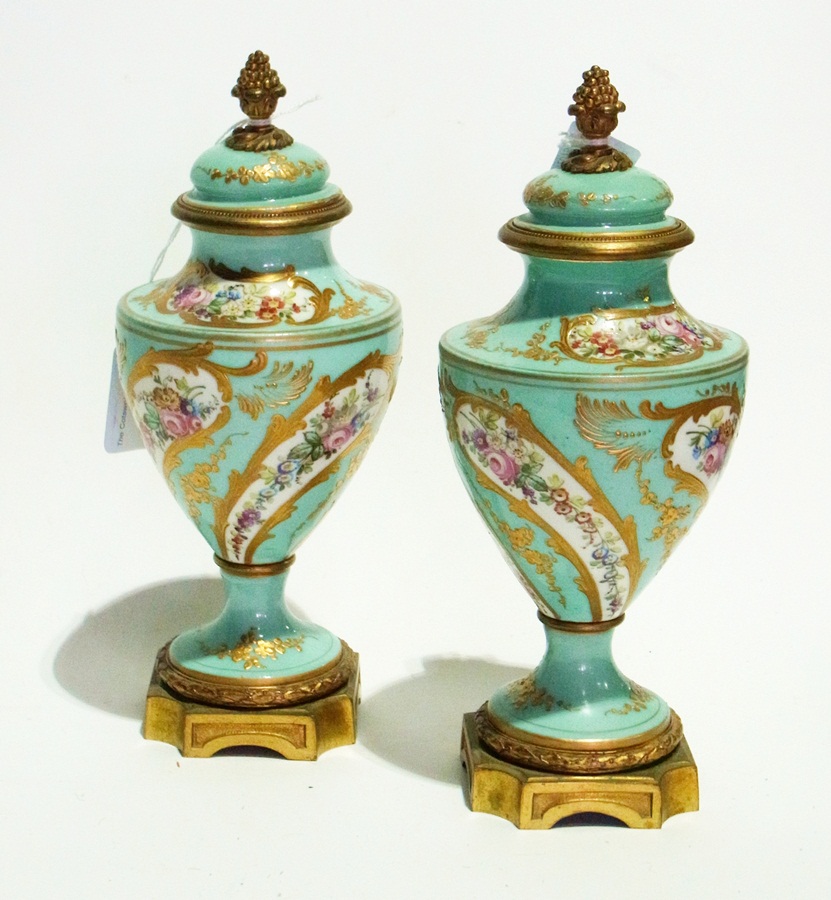 A pair of Sevres porcelain lidded urns w
