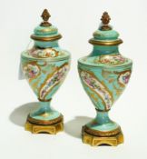 A pair of Sevres porcelain lidded urns w