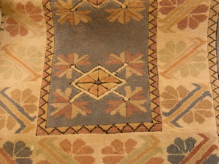 Wool rug with blue ground with stylised