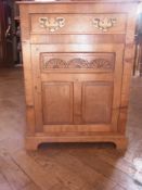 An oak side cupboard with frieze drawer,