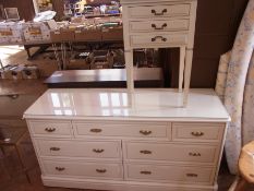 A modern white painted chest of seven dr