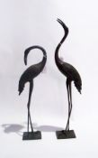 Two bronze-effect cranes and an African