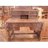 A Victorian carved oak desk, the raised