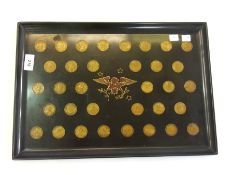 A lacquer tray with inset US coins and a