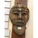 A wooden African mask, a small African m