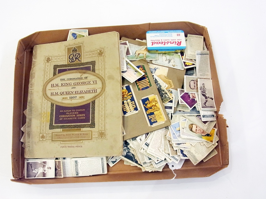 A large collection of cigarette cards in
