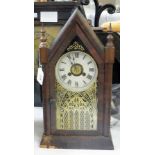 Stained wood mantel clock in pointed cas