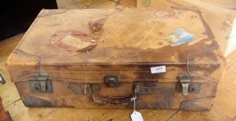 Old leather suitcase with travel labels