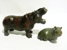 A collection of hippos, including bronze