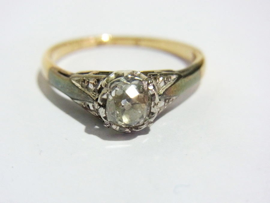 Gold and platinum solitaire diamond ring
