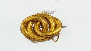 Gold coloured metal brooch in the form three interlinked ovals and circles,