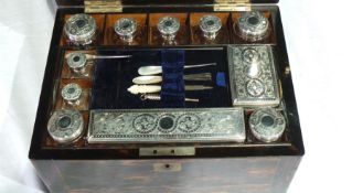 A Victorian coromandel brass-mounted travelling vanity case having comprehensively fitted interior,