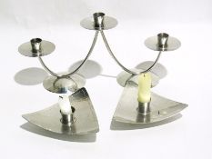 A miniature desk globe mounted in brass, a stainless steel hammered three-light candelabrum,