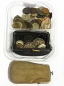 A collection of world coins and two purs