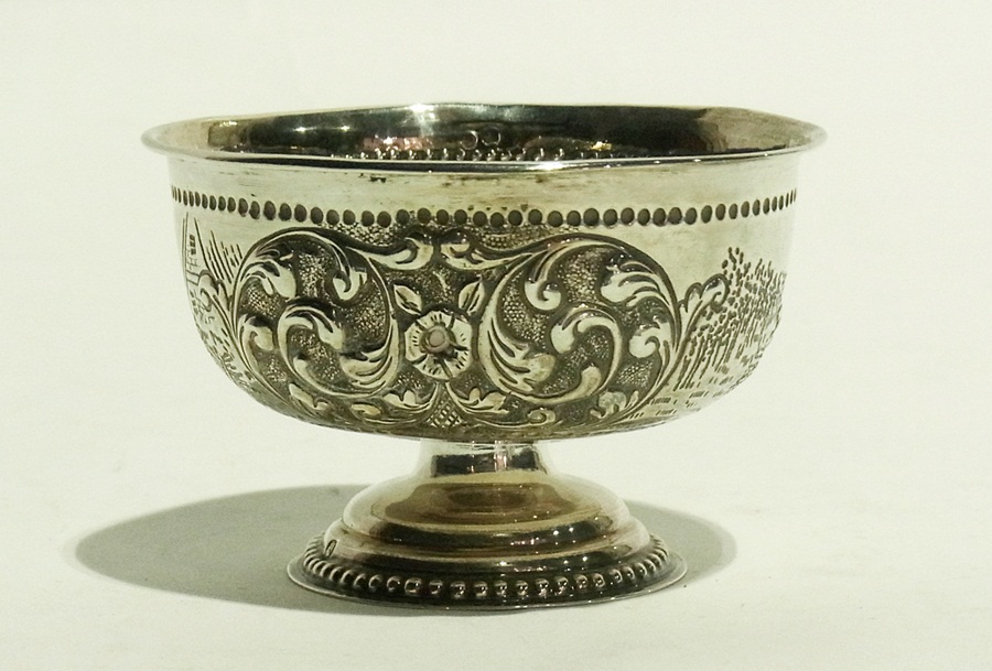 Silver pedestal bowl with repousse scroll decoration interspersed with harvest scenes bearing