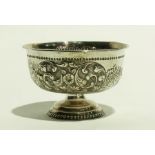 Silver pedestal bowl with repousse scroll decoration interspersed with harvest scenes bearing