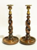 Two wooden turned candlesticks with bras