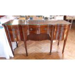 George III mahogany wavy front sideboard with frieze drawer above tambour-fronted shelf,