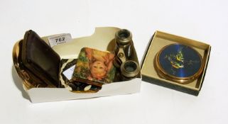A pair of theatre binoculars, a compact,